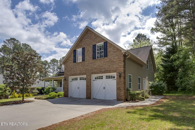 100 Coyatee Cir, Loudon, TN 37774 - view of side of property featuring a lawn, driveway, brick siding, and an attached garage