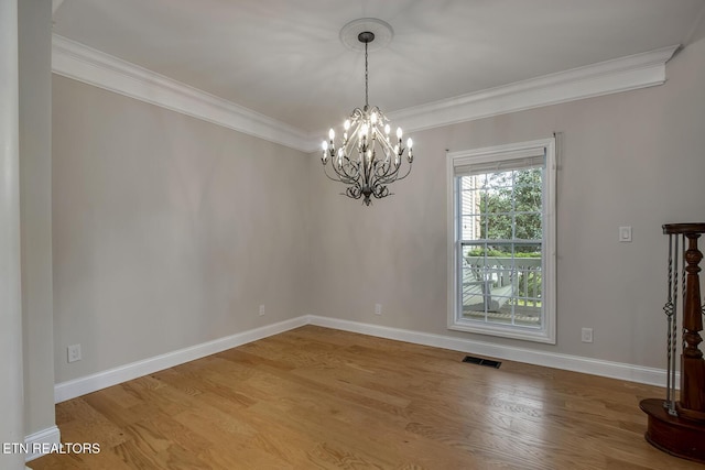 100 Coyatee Cir, Loudon, TN 37774 - empty room with a notable chandelier, baseboards, visible vents, crown molding, and wood finished floors