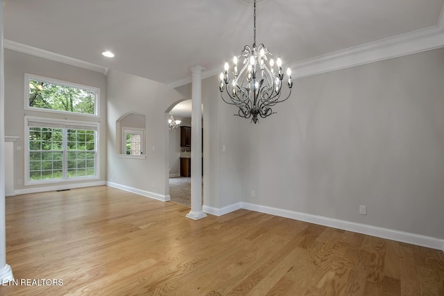 100 Coyatee Cir, Loudon, TN 37774 - unfurnished dining area with arched walkways, a notable chandelier, ornamental molding, and light wood-style floors