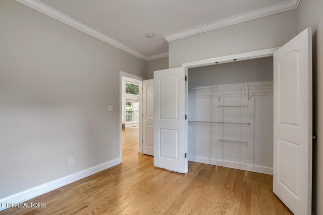 100 Coyatee Cir, Loudon, TN 37774 - unfurnished bedroom with baseboards, ornamental molding, a closet, and light wood-style flooring