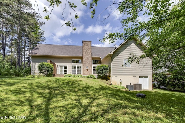 100 Coyatee Cir, Loudon, TN 37774 - rear view of house featuring central AC unit, a chimney, and a lawn