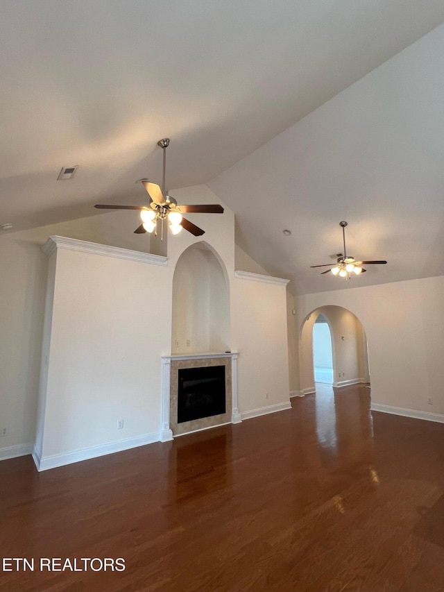 unfurnished living room with a ceiling fan, baseboards, and vaulted ceiling