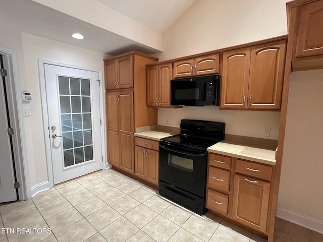 kitchen featuring light countertops, brown cabinetry, black appliances, and lofted ceiling