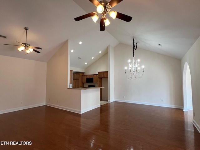 unfurnished living room featuring arched walkways, ceiling fan with notable chandelier, dark wood-style flooring, and high vaulted ceiling