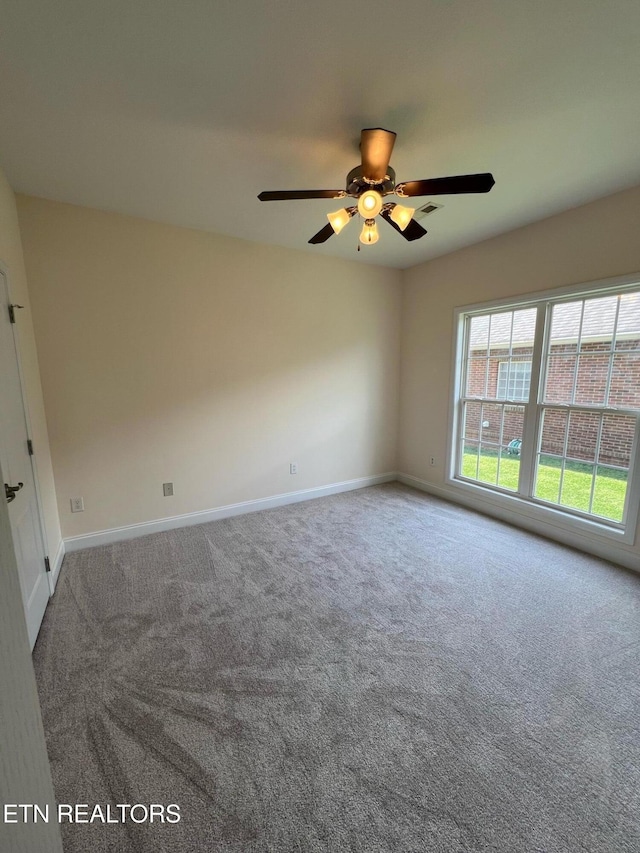 spare room featuring baseboards, carpet, and ceiling fan