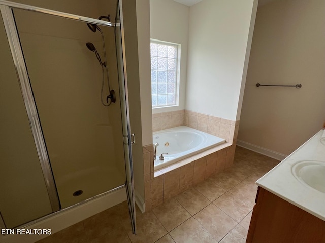 bathroom with vanity, tile patterned floors, a stall shower, and a tub with jets