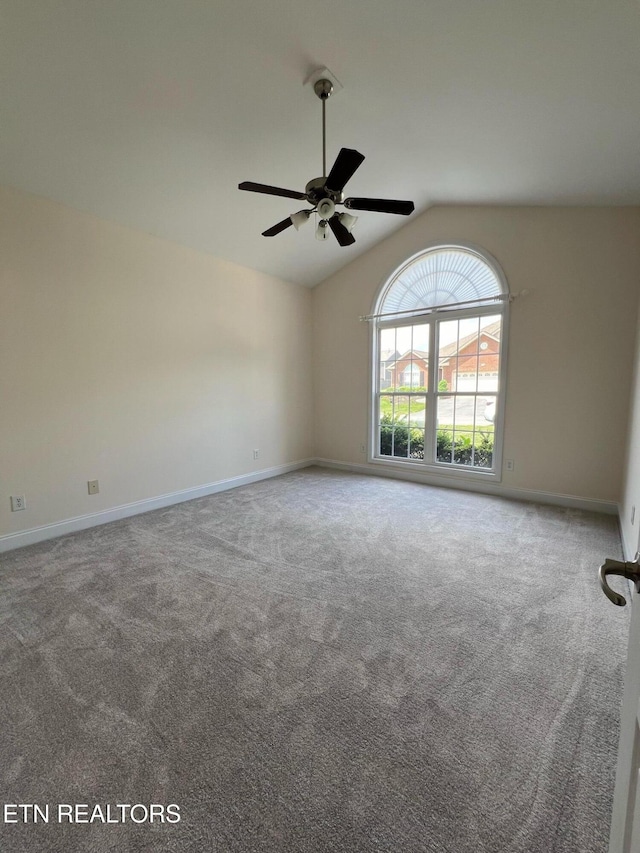 carpeted spare room featuring baseboards, a ceiling fan, and lofted ceiling