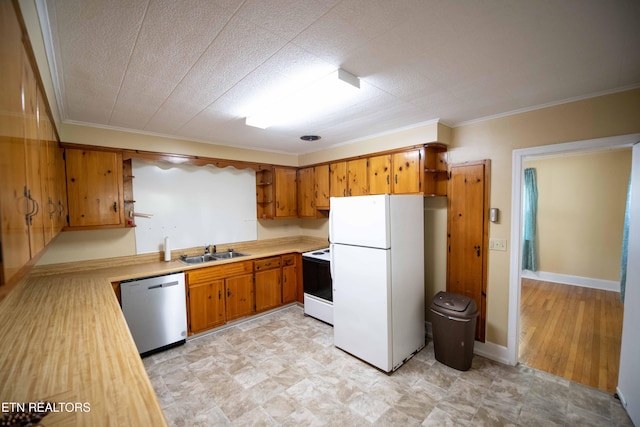 kitchen featuring open shelves, a sink, dishwasher, range with electric cooktop, and freestanding refrigerator