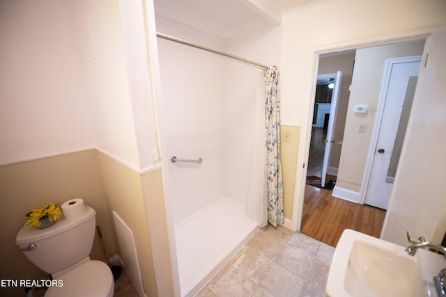 full bath with toilet, a sink, and a stall shower