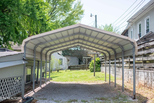 view of vehicle parking with a detached carport and fence