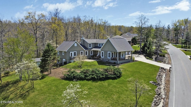 bird's eye view with a wooded view