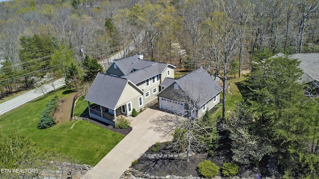 drone / aerial view featuring a wooded view