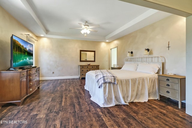 bedroom featuring a tray ceiling, ceiling fan, baseboards, and dark wood-style flooring