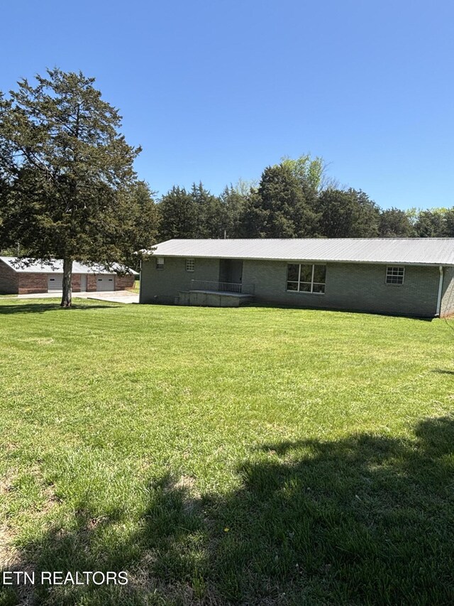 back of house with a lawn