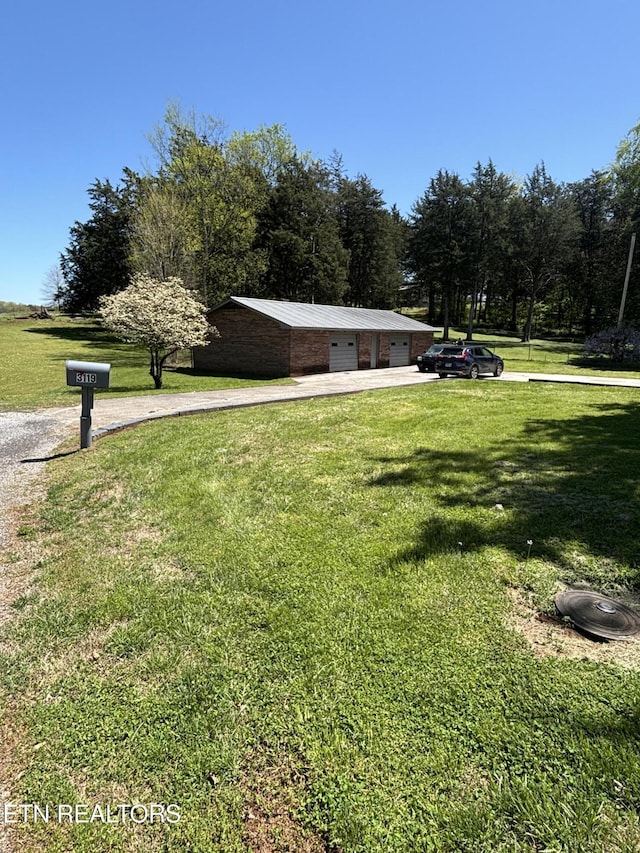 view of property's community with a garage and a lawn