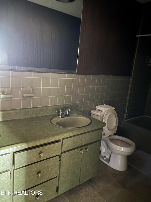 full bath featuring decorative backsplash, toilet, vanity, and tile patterned floors