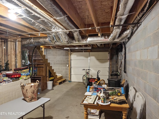 unfinished basement with concrete block wall and stairs