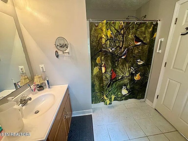 full bathroom with vanity, tile patterned flooring, baseboards, and a shower with curtain