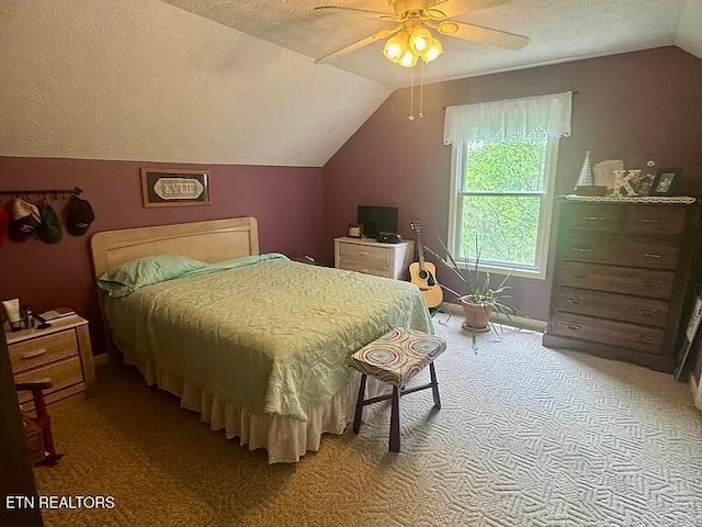 bedroom featuring a textured ceiling, lofted ceiling, and light carpet