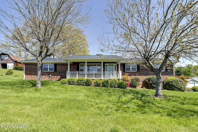 ranch-style house featuring a front lawn, covered porch, and brick siding