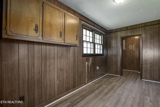 interior space with wood walls and wood finished floors