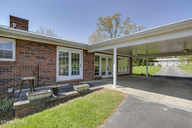exterior space featuring french doors, a ceiling fan, and an attached carport