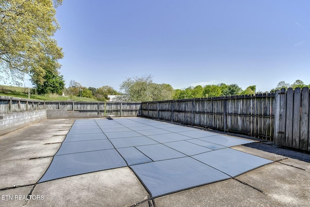view of pool with a patio and a fenced backyard