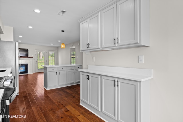 8411 Ivy Green Way, Knoxville, TN 37919 - kitchen featuring visible vents, a glass covered fireplace, recessed lighting, light countertops, and dark wood-type flooring