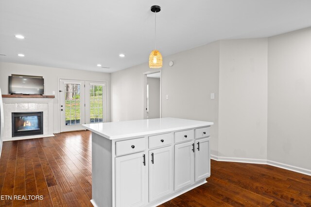 8411 Ivy Green Way, Knoxville, TN 37919 - kitchen featuring decorative light fixtures, a high end fireplace, open floor plan, and dark wood-style flooring