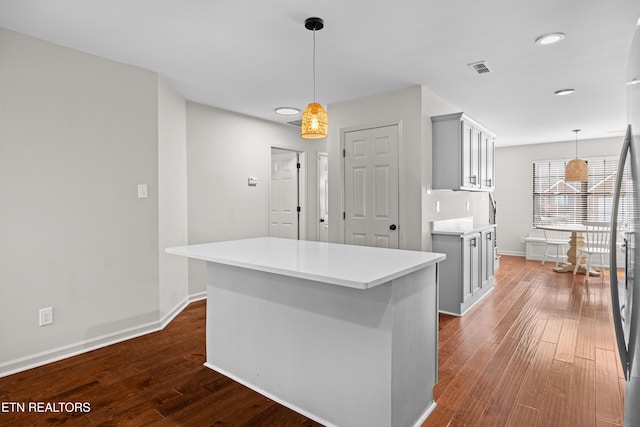8411 Ivy Green Way, Knoxville, TN 37919 - kitchen with dark wood finished floors, light countertops, a center island, baseboards, and hanging light fixtures