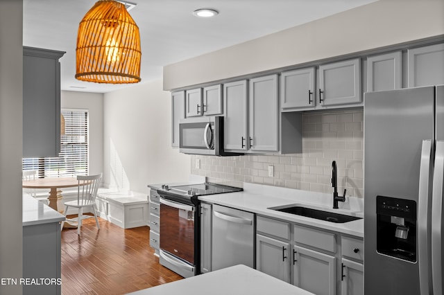 8411 Ivy Green Way, Knoxville, TN 37919 - kitchen with a sink, backsplash, gray cabinets, light countertops, and appliances with stainless steel finishes