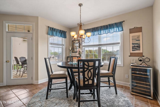 1079 Rarity Bay Pkwy, Vonore, TN 37885 - tiled dining space with an inviting chandelier, beverage cooler, and baseboards