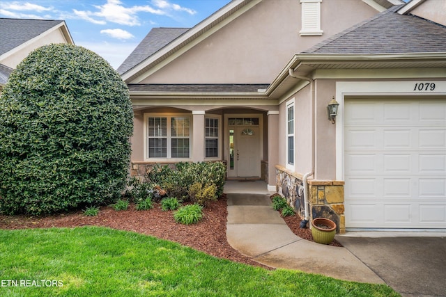1079 Rarity Bay Pkwy, Vonore, TN 37885 - property entrance with an attached garage, stone siding, stucco siding, and a shingled roof