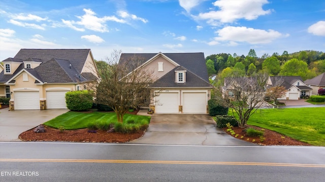 1079 Rarity Bay Pkwy, Vonore, TN 37885 - view of front of property featuring a shingled roof, stucco siding, an attached garage, concrete driveway, and a front yard