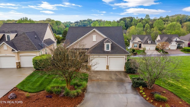 1079 Rarity Bay Pkwy, Vonore, TN 37885 - traditional-style home with a residential view, driveway, stucco siding, and roof with shingles