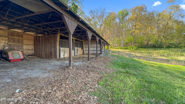 view of outdoor structure featuring a carport, an outbuilding, and an exterior structure