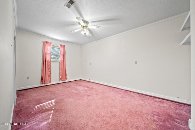 spare room with ornamental molding, a textured ceiling, visible vents, ceiling fan, and carpet