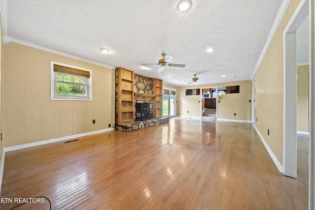 unfurnished living room with visible vents, ornamental molding, light wood-style flooring, and ceiling fan