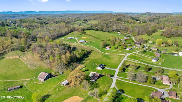 birds eye view of property with a wooded view