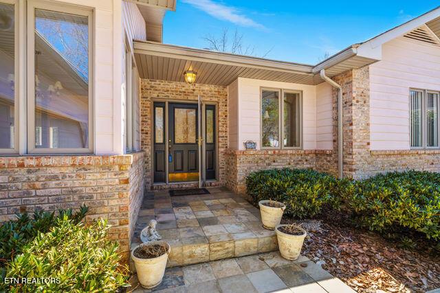 doorway to property with brick siding
