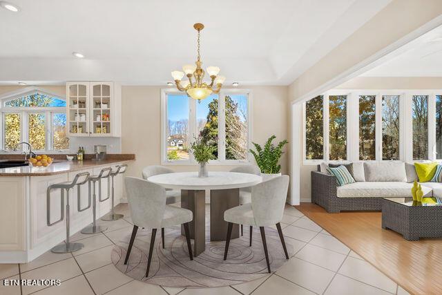dining area featuring a chandelier, recessed lighting, and light tile patterned floors