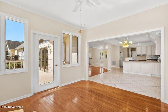 interior space featuring visible vents, baseboards, and crown molding
