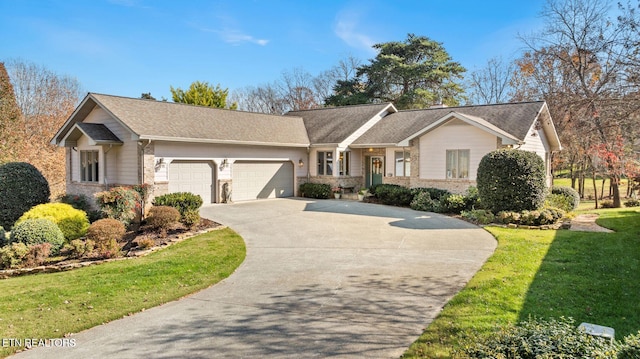 single story home with a shingled roof, concrete driveway, stone siding, a front yard, and a garage