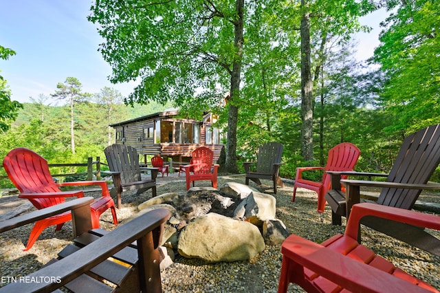 view of patio / terrace with an outdoor fire pit and an outdoor structure