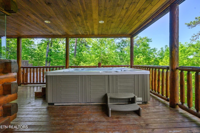 wooden deck with an outdoor hot tub