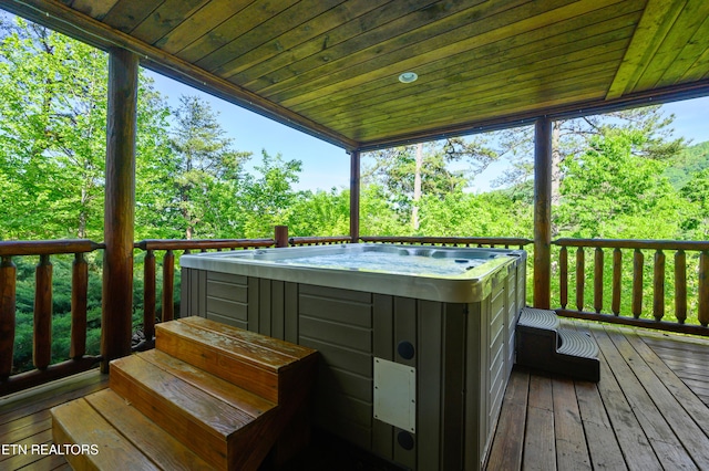 wooden deck with a hot tub