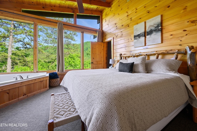 bedroom with wood walls, lofted ceiling with beams, light carpet, and wooden ceiling