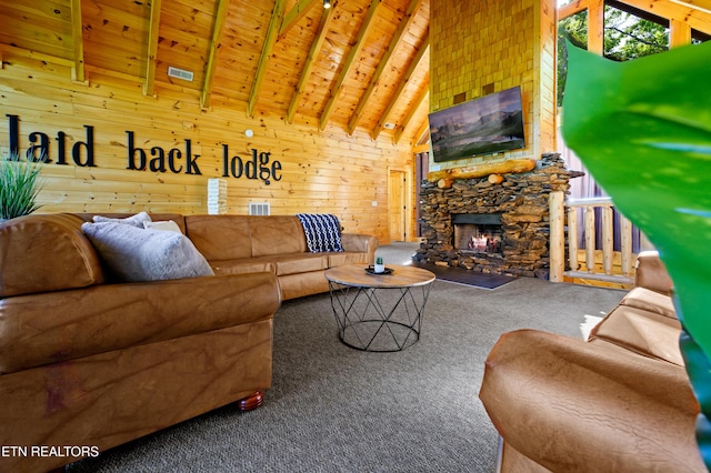 carpeted living room featuring visible vents, beamed ceiling, wood ceiling, wooden walls, and a fireplace