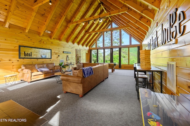 living room featuring high vaulted ceiling, wooden walls, and carpet