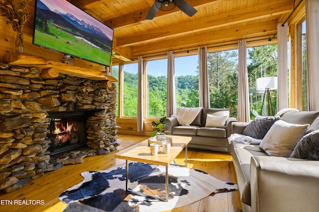 sunroom / solarium with beamed ceiling, hardwood / wood-style flooring, and wooden ceiling